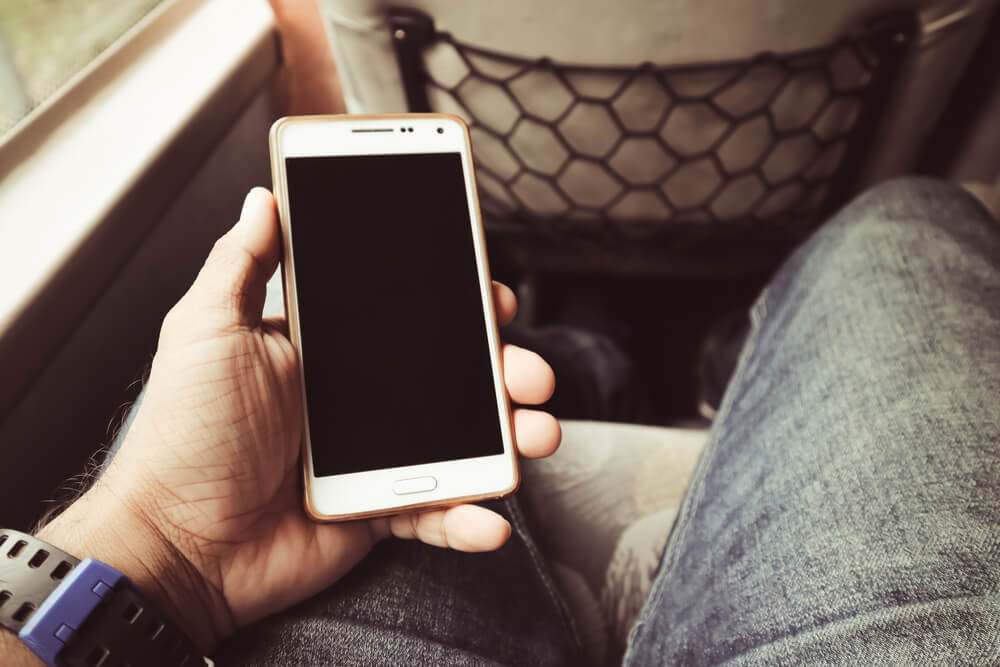 Hombre con un móvil en el autobús