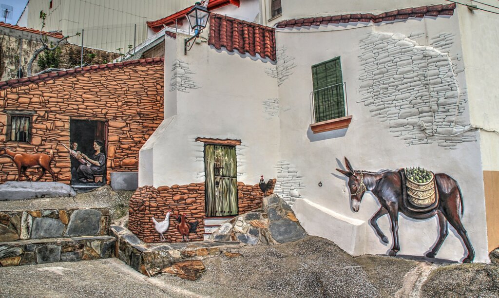 Mural en la ciudad de Romangordo que refleja la vida rural del pueblo.